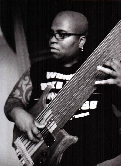 Above Count the number of strings on Michelle Webb's instrument 