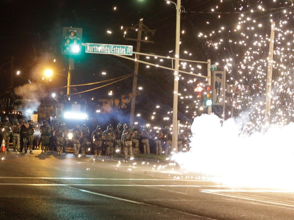 PHOTO: A device deployed by police goes off in the street as police and protesters clash Wednesday, Aug. 13, 2014, in Ferguson, Mo., the St. Louis suburb where an unarmed black teen was shot and killed by a police officer.