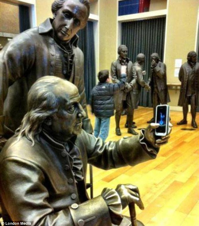 Updated: Benjamin Franklin is using an iPhone to take a 'selfie' photograph in this surreal picture