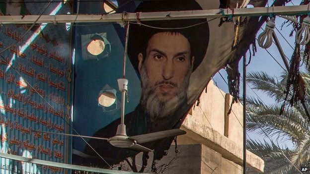A burnt poster of Iraqi Shia cleric Mahmoud al-Sarkhi in Karbala (2 July 2014)