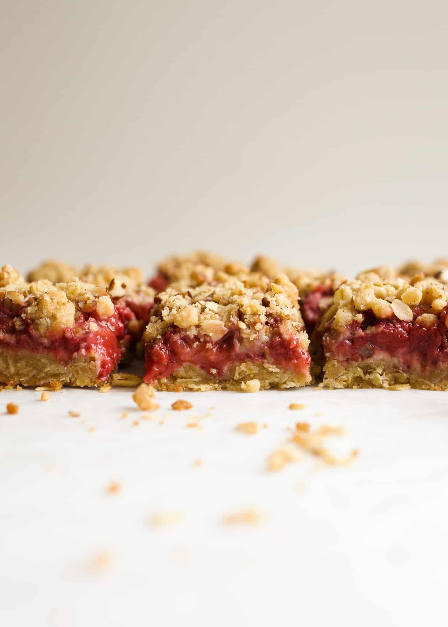 Strawberry Rhubarb Crumb Bars by Wood and Spoon blog are simple, make ahead jam filled bars made from spring fruit. The tart rhubarb makes a quick preserve with strawberries for a gooey centered oatmeal cookie bar. You can use fresh or frozen fruit for the jam and add additional fruit to make extra thick and fruity bars. Check out the recipe and how-to on thewoodandspoon.com