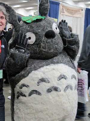 A cosplayer portraying Totoro from My Neighbor...