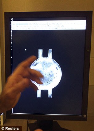 Senior conservator Paul Mardikian looks at the x-ray of a portal on the Hunley 