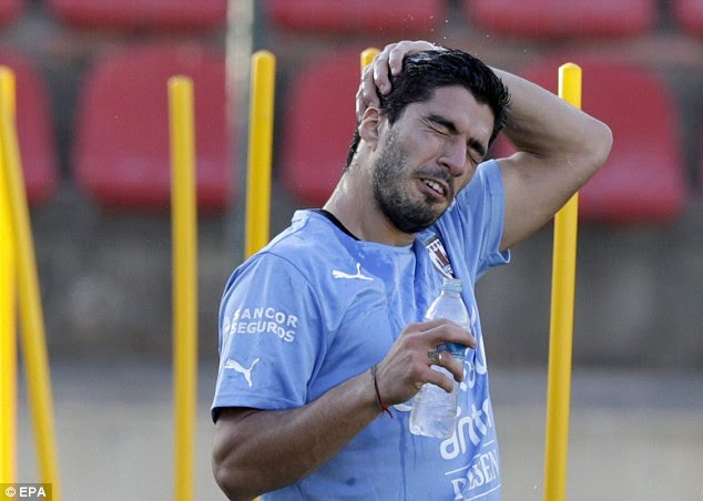 Working up a sweat: Suarez trained on his own away                from the rest of the squad