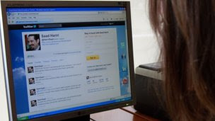 A woman looks at former Lebanese prime minister Saad al-Hariri"s Twitter page 