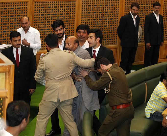 MLA Langate Er Rasheed being marshalled out of the J&K Assembly on Monday during the budget presentation. (KL Image: Bilal Bahadur)