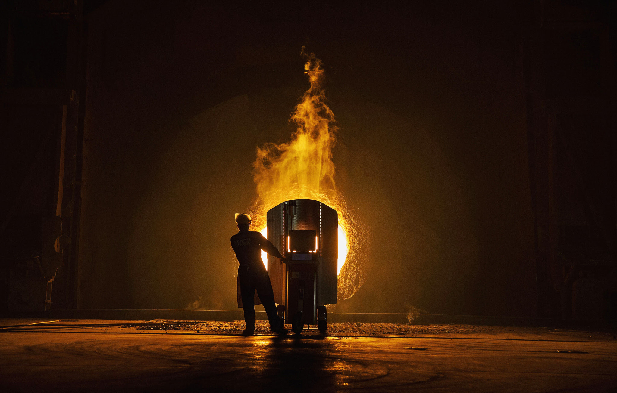 CHANGZHOU, CHINA - MAY 12: A worker takes samples for quality of molten iron outside a furnace at the Zhong Tian (Zenith) Steel Group Corporation on May 12, 2016 in Changzhou, Jiangsu. Zhong Tian (Zenith) Steel Group Corporation is a privately-owned manufacturer that employs over 13,000 workers at its facility in China's eastern Jiangsu province. Since 2001, the company says it has adopted new technology to streamline the production of premium quality steel and to reduce environmental impact. The majority of its steel output is for the Chinese market with 20% earmarked for export, mostly to Asia. The company says it is profitable, but admits business has dropped marginally from past years. China is the world's largest steel producer, accounting for over 50% of global supply. China's government has vowed to cut production capacity at state-owned enterprises by up to 150 million tonnes over five years to ease concerns of an oversupply on global markets. However, its efforts appear to be overshadowed by a recent increase in steel prices that has revived production at some Chinese facilities that had been closed down. (Photo by Kevin Frayer/Getty Images)