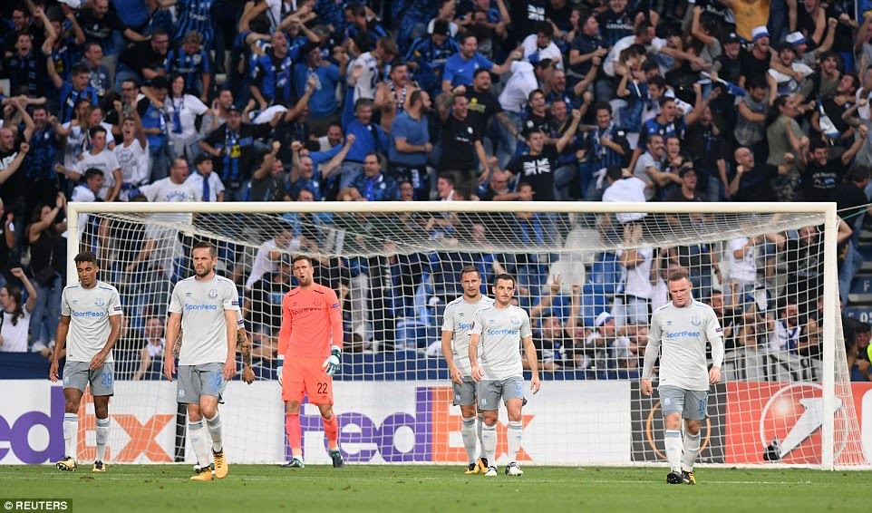 Everton's players look dejected after falling behind as the home fans are sent into raptures by Masiello's opening goal