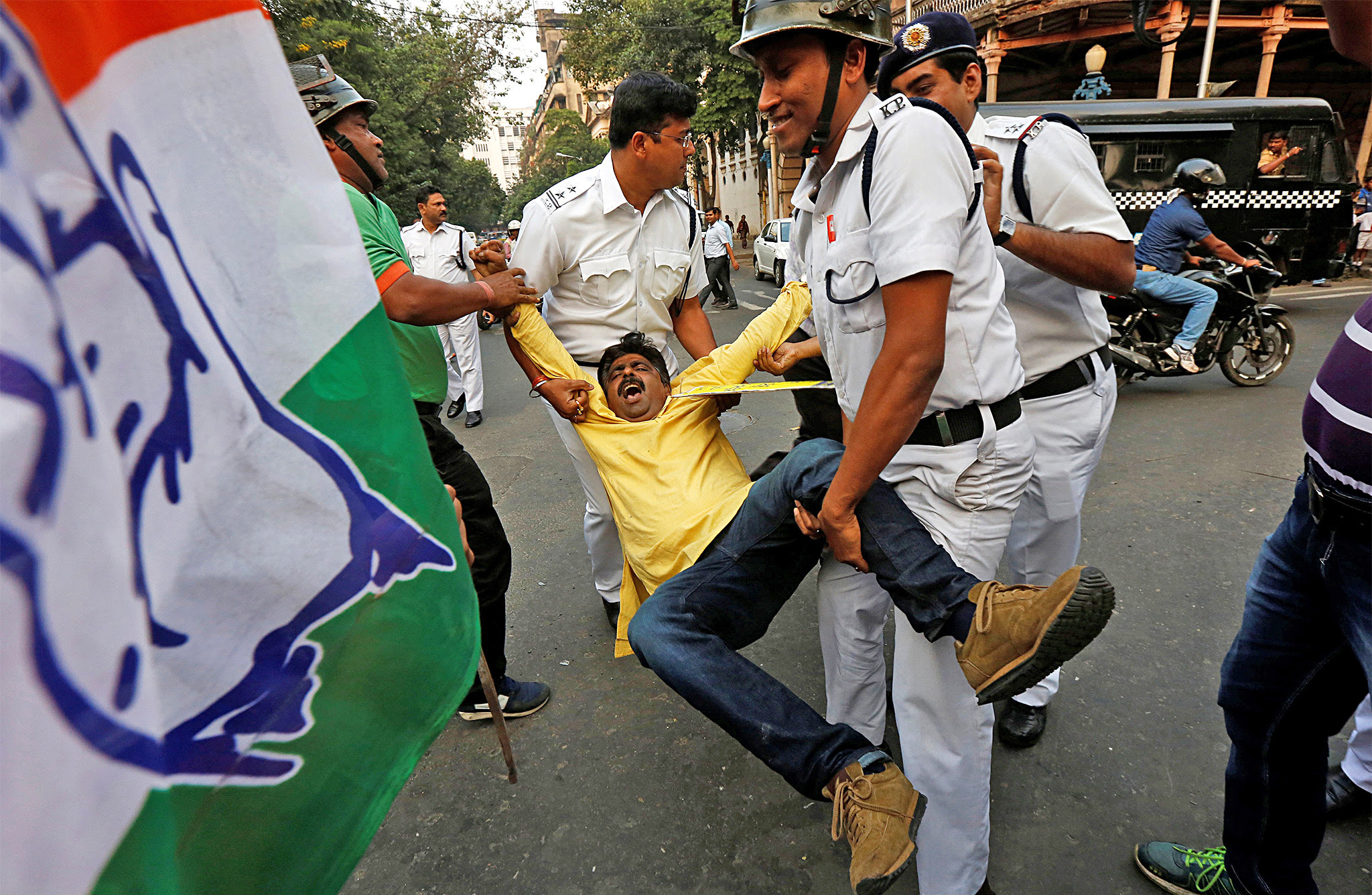 Police detain a protester from India's main opposition Congress party during a protest in Kolkata