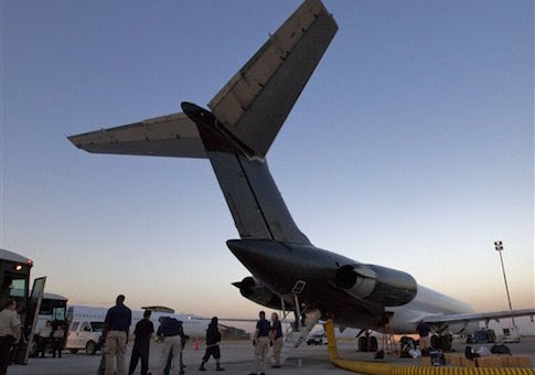 Illegal immigrants from El Salvador are boarded on an MD-80 aircraft for a repatriation flight carrying 80 immigrants to their home country at dawn