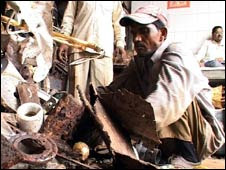 A man sorting through scrap metal