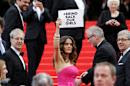 Actress Salma Hayek holds up a sign reading "bring back our girls", part of a campaign calling for the release of nearly 300 abducted Nigerian schoolgirls being held by Nigerian Islamic extremist group Boko Haram, as she arrives for the screening of Saint-Laurent at the 67th international film festival, Cannes, southern France, Saturday, May 17, 2014. (AP Photo/Thibault Camus)