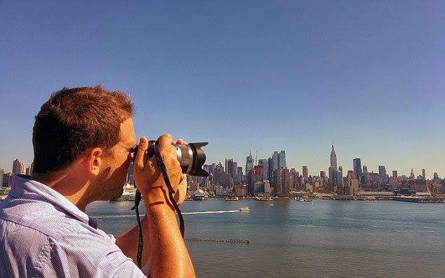 Ben is pictured honing his photography skills in New York, one of the locations where they have house-sat