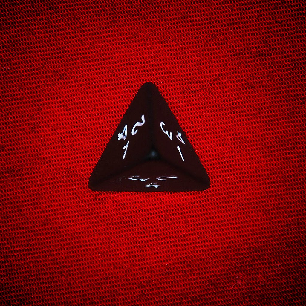 A 4-sided die on a bright red background.