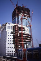 Docklands Light Railway - Tower Cranes and The DLR.   Construction of Canary Wharf, Heron Quays station,Aug 1990