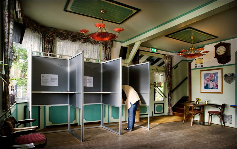 A woman stands in a voting booth on June 4, 2009 in the Dutch city of Zaanstad