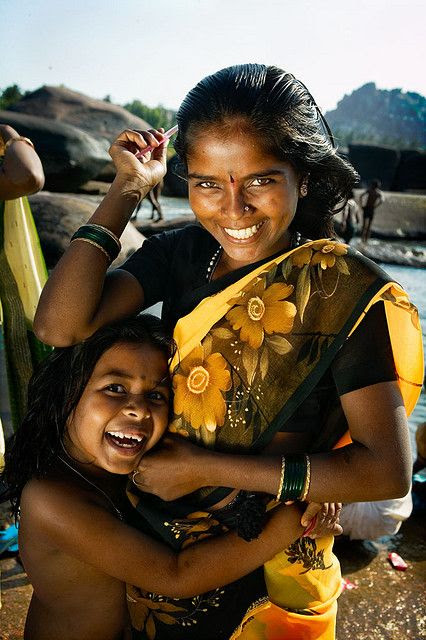 Mother and daughter combing their hair at a ghat in Kerala, India. by phitar.
