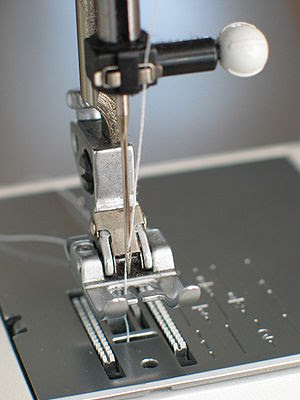 Needle plate, foot and transporter of a sewing...