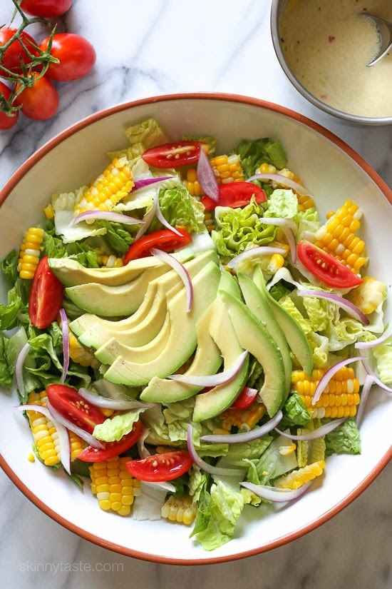 Take advantage of the end of summer with sweet corn and delicious ripe tomatoes with this easy side dish, perfect to go along anything you 're grilling! The dressing is creamy yet light, the perfect compliment.