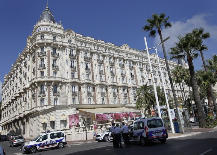 Police cars stand outside the Carlton Intercontinental Hotel in Cannes, southern France, 28 July 2013. EPA/SEBASTIEN NOGIER