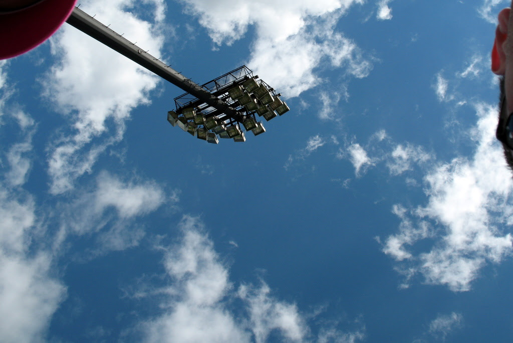 looking up at the sky with baseball lights in the background