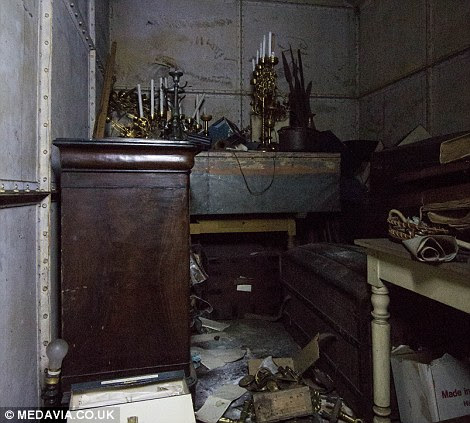 A store room in the basement of the chateau is piled high with abandoned possessions, left