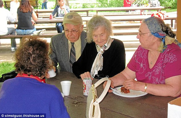 In secret: The former Nazi is seen enjoying a Father's Day picnic in 2011 sporting the hat