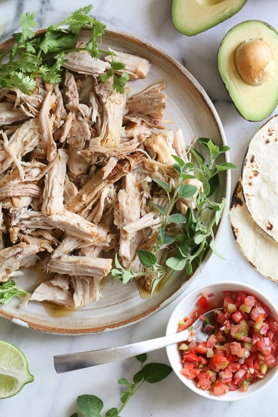Tender shredded pork, marinated in garlic, cumin, grapefruit and lime and cooked in the pressure cooker is perfect to serve over a bed of rice or with tortillas and salsa and avocados for taco night.