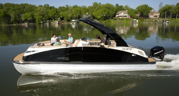 Harris FloteBote Crowne 250 gracefully glides past the waterfront ...