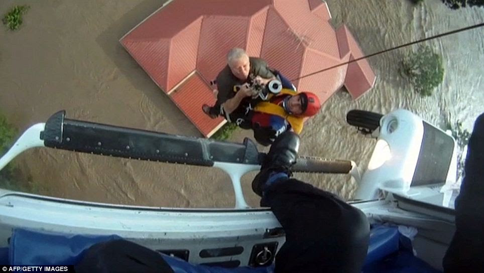 Dramatic rescue: Army helicopters have been brought in to help lift people trapped on their rooftops