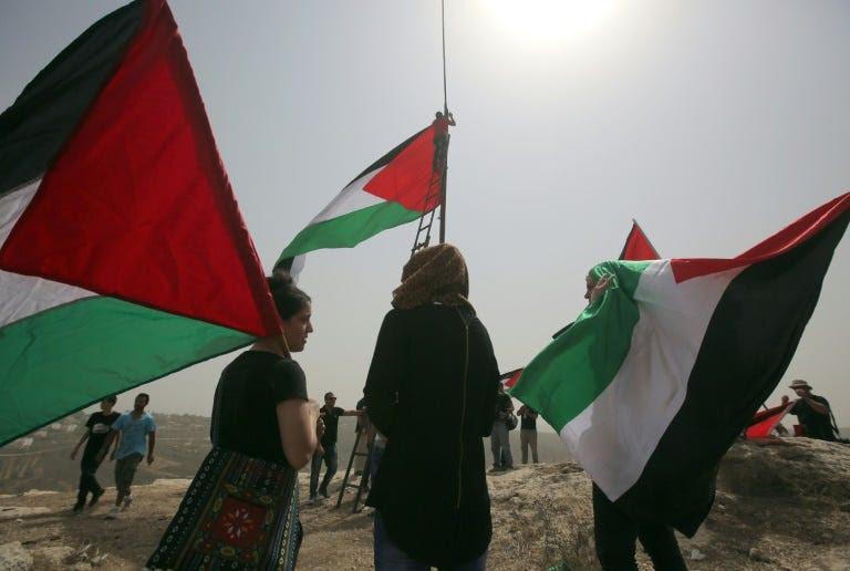 The General Assembly voted September 10 to allow the flags of Palestine, pictured, and the Vatican -- both have observer status -- to be raised at the world body alongside those of member states
