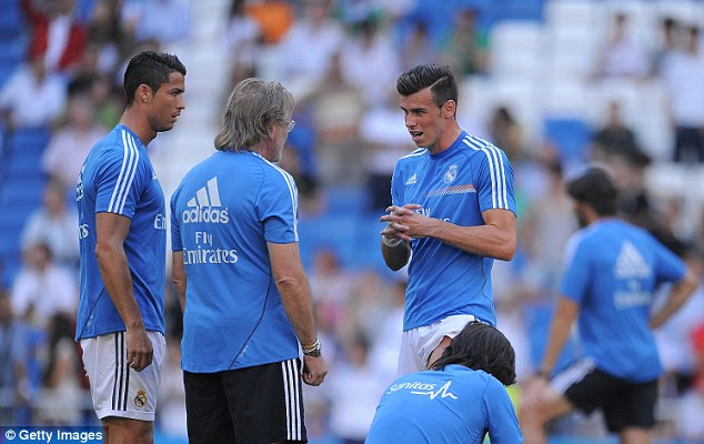 Anxious: Bale taking with Cristiano Ronaldo and the Real Madrid backroom staff