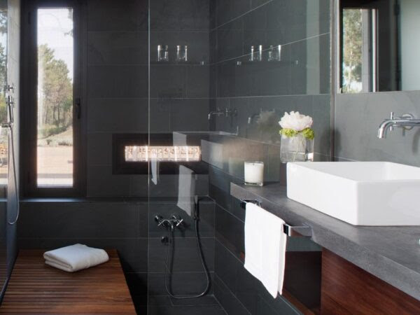 The bathrooms have their own careful luxury with this dark gray slate tile.