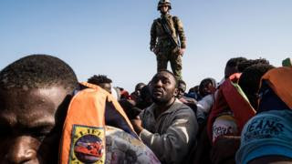 A Libyan coastguard atop a boat during the rescue of 147 illegal immigrants attempting to reach Europe off the coastal town of Zawiyah, west of the capital Tripoli, on June 27, 2017.