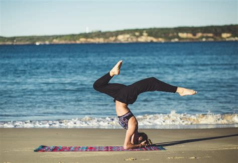 fit woman  headstand yoga pose outdoors high