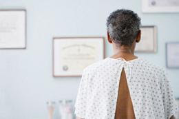 man wearing hospital gown