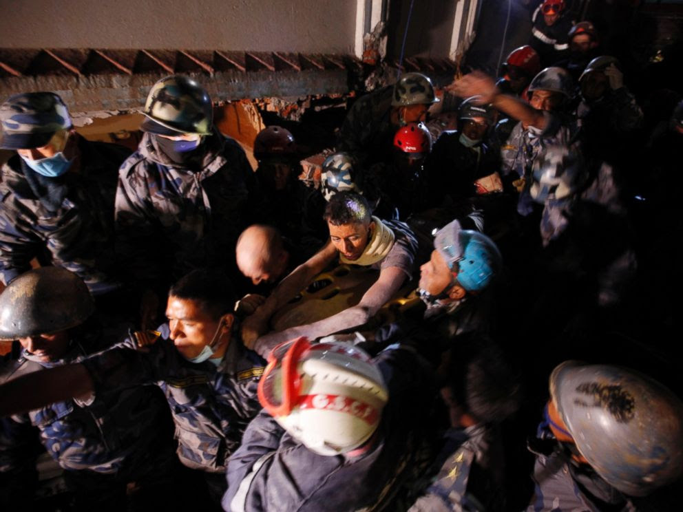 PHOTO: Survivor Rishi Khanal, 27, is freed by French rescuers from the ruins of a three-story hotel in the Gangabu area of Kathmandu, Nepal, April 28, 2015.