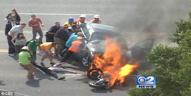 Heroic: Innocent bystanders rushed to help the trapped biker