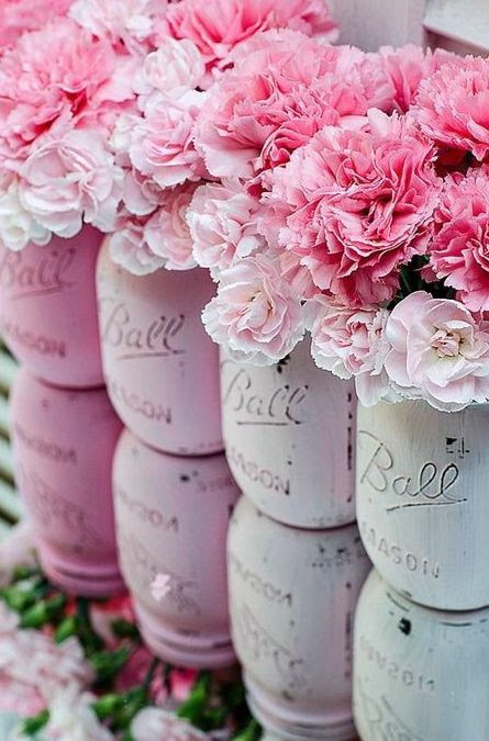 Pink mason jars filled with pink flowers! Perfect decorations or centerpieces for your pink party.