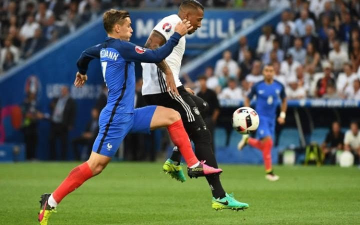 France's forward Antoine Griezmann (L) vies for the ball with Germany's defender Jerome Boateng during the Euro 2016 semi-final football match between Germany and France