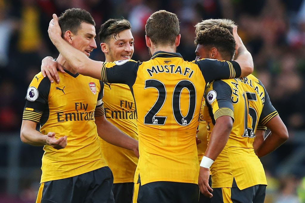 Laurent Koscielny celebrates scoring with his team mates