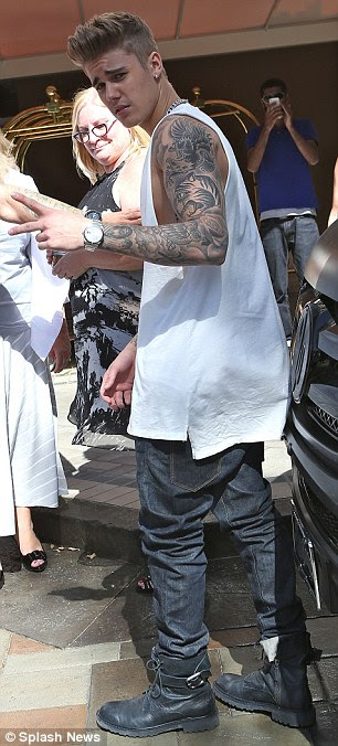 Trouble brewing: Bieber was his typical brash self at the Four Seasons on Mother's Day, but behind the scenes the Los Angeles District Attorney's office are weighing up his potential punishment