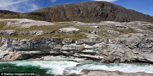 The discovery was made when the interior of a container, which was unearthed in Baffin Island (pictured), was found to contain bronze as well as small spherules of glass