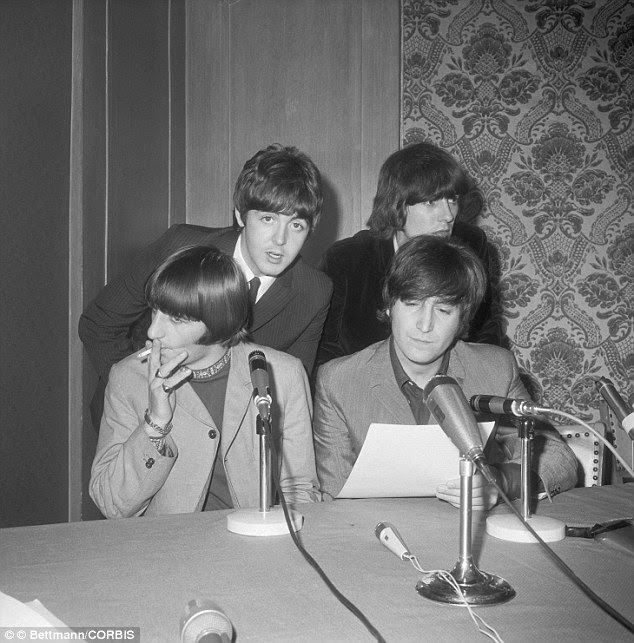 The Beatles, (front) Ringo Starr and John Lennon, and (back) Paul McCartney and George Harrison are seen here at a press conference at the Hotel Warwick following their arrival to the U.S. from the UK in 1965