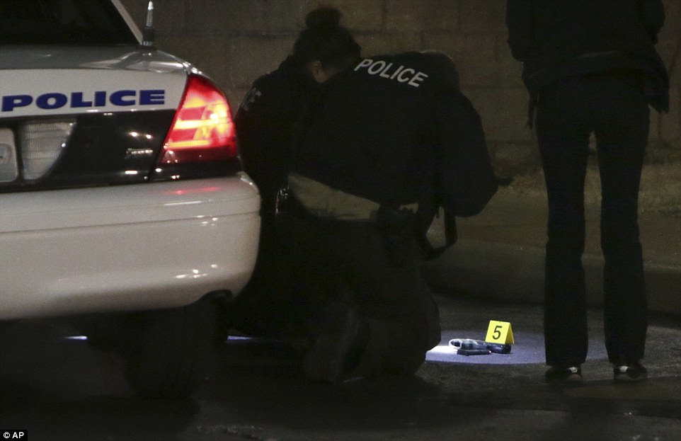 Weapon: Police investigators found a gun at the scene of the shooting, pictured, in Berkeley, Missouri
