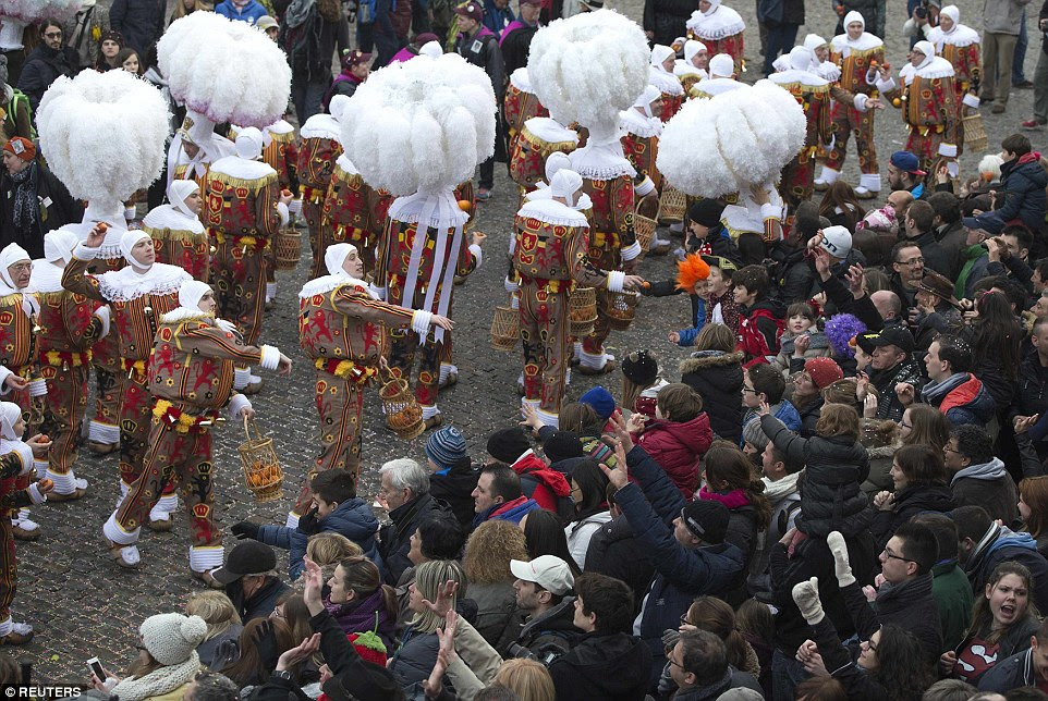 Chuck those oranges boys: The Binche carnival, a UNESCO World Heritage event, is the biggest and the liveliest annual event in Belgium