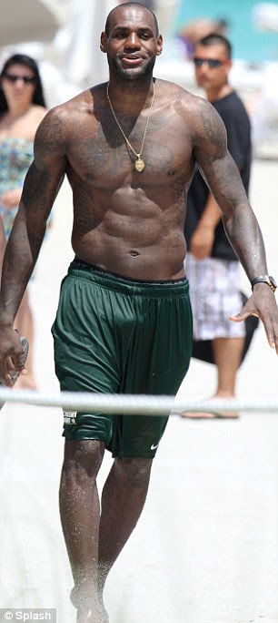Game on his mind: The 6ft8 basketball star kept comfortable in a pair of basketball shorts as swimming trunks