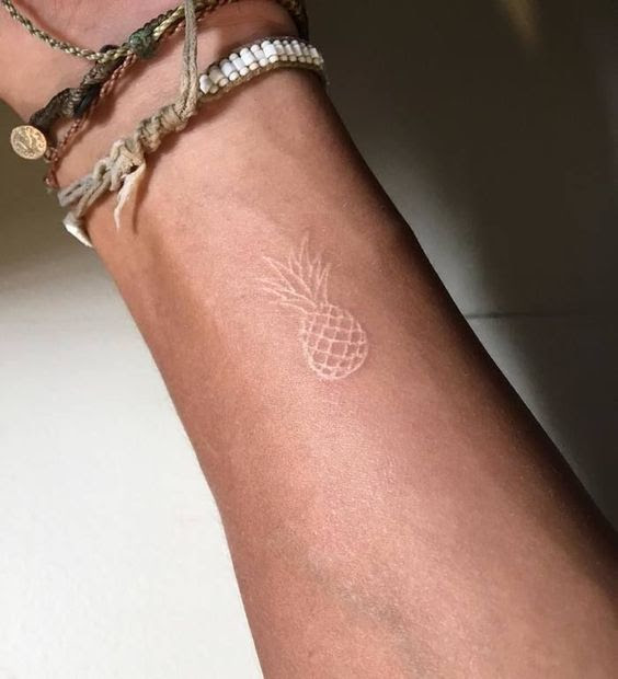 white ink tattoos on tan skin