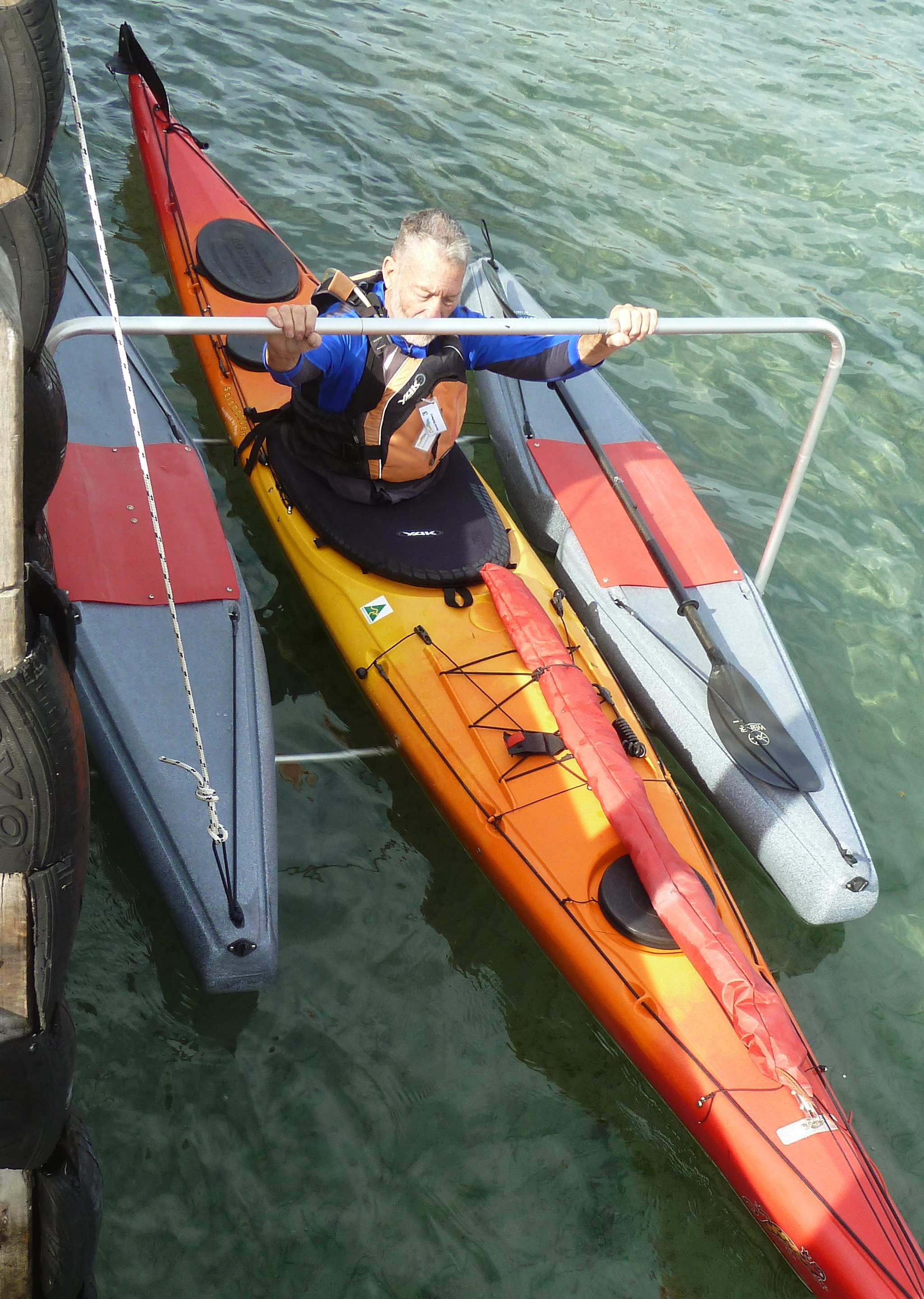 Floating kayak dock system for launching kayaks and canoes