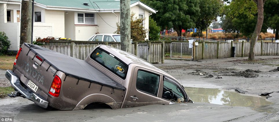 Destruction: A vehicle stuck in the road after the ground broke up